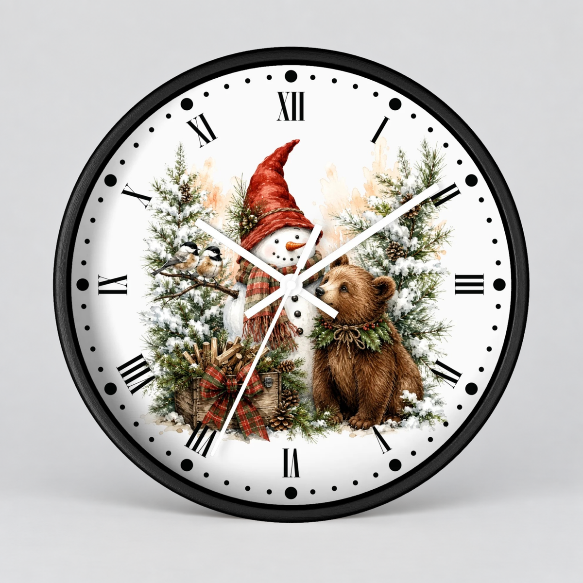 A round wall clock with a black frame and a white face featuring a winter holiday illustration of a snowman in a red hat beside a brown bear among snowy trees. Roman numerals mark the hours, with white hands and black dot hour indicators.
