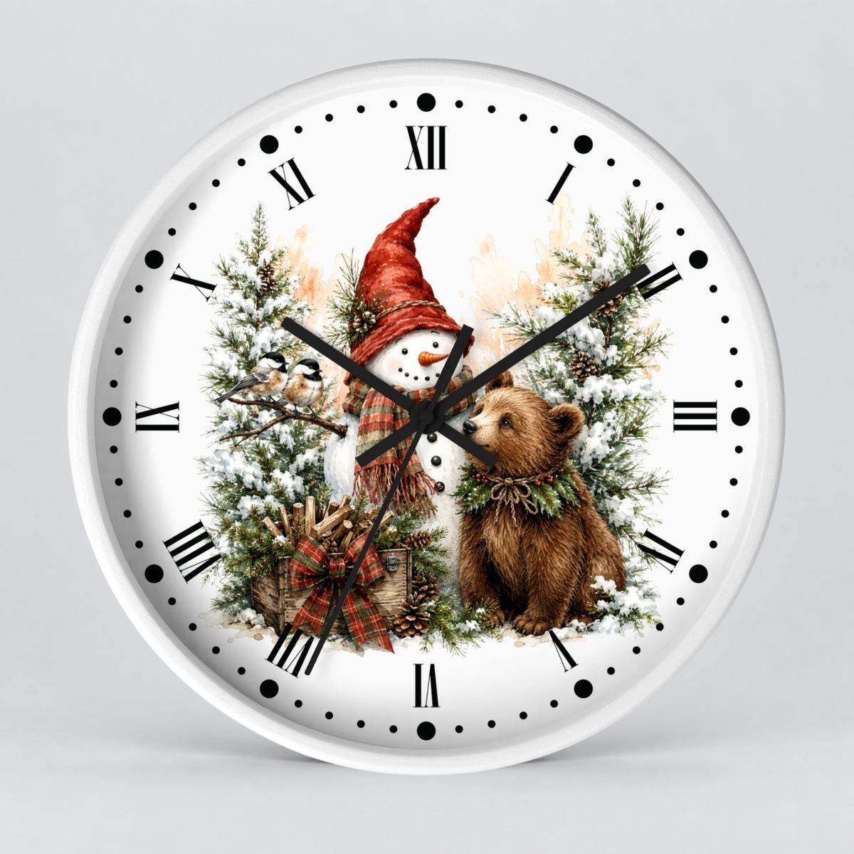 A round white wall clock with black Roman numerals and hour markers, featuring a festive Christmas illustration on the face with a snowman in a red hat, evergreen trees, a plaid bow, and a brown bear wearing a green wreath, shown against a light gray background.