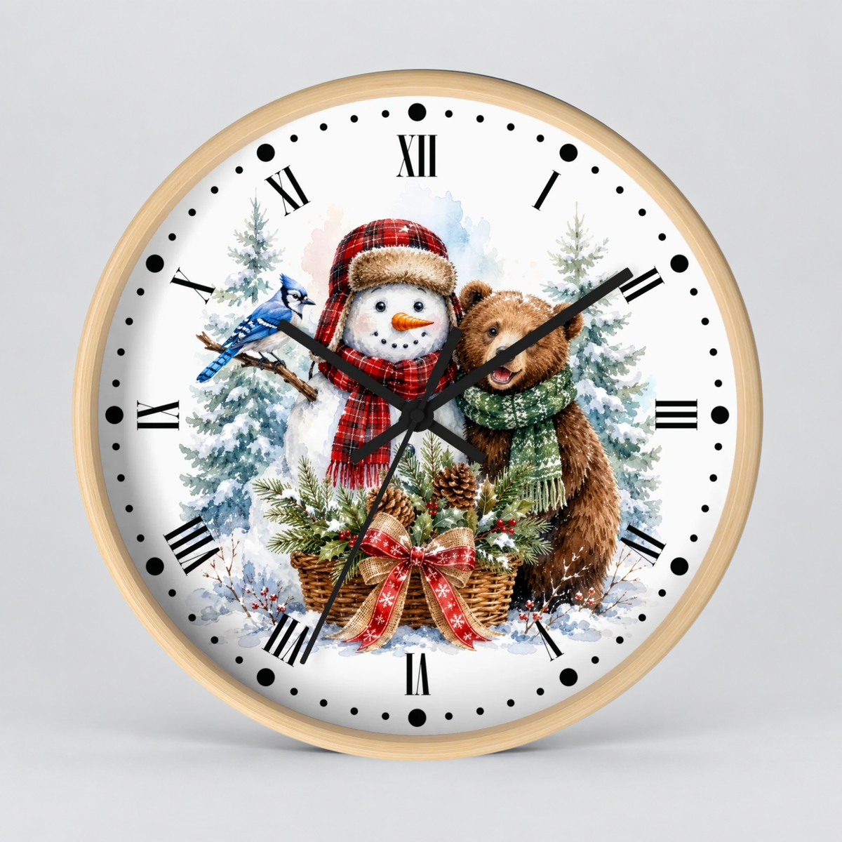 A round wall clock with a light wood frame and a festive winter illustration on the dial. The design shows a snowman in a red plaid hat and scarf, a bluebird, a brown teddy bear in a green scarf, evergreen trees, pinecones, and a snowy scene.