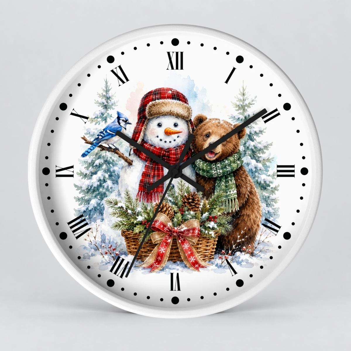 A round white wall clock with a festive winter illustration on the face, featuring a snowman in a red plaid hat and scarf, a brown bear in a green scarf, pine trees, and a blue bird, shown against a light gray background.