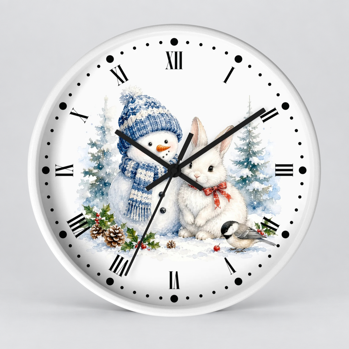 A round white wall clock with black Roman numerals and hands, featuring a festive winter illustration on the face with a snowman in a blue knit hat, a white rabbit with a red bow, evergreen trees, pinecones, and small birds, shown against a light gray background.