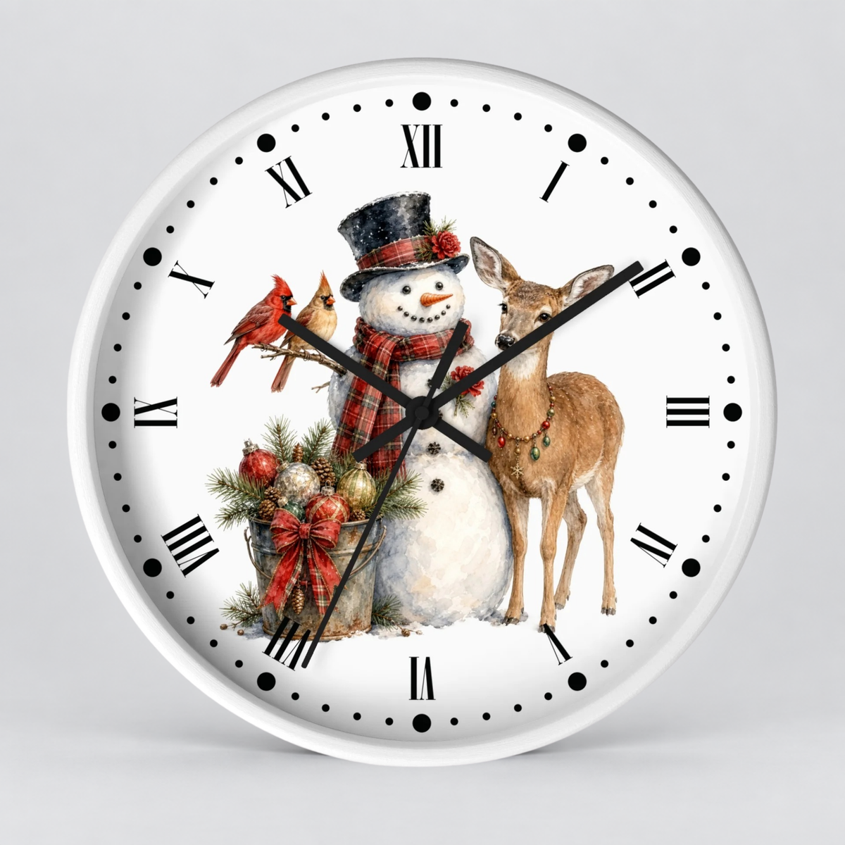 A round white wall clock with black Roman numerals and hands, featuring a festive winter illustration of a snowman in a top hat and scarf, a brown deer, two red cardinals, and holiday greenery on a light gray background.