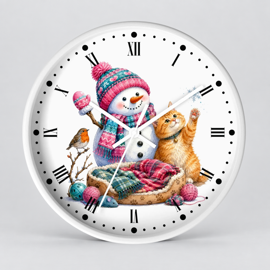A round white wall clock with black Roman numerals and hands, featuring a colorful printed illustration of a snowman in a pink knit hat next to an orange tabby cat, a small bird, and knitting balls on a light gray background.
