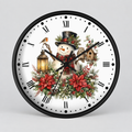 A round wall clock with a black frame and a white face featuring a festive Christmas design. The design includes a snowman wearing a black top hat and red scarf, surrounded by red poinsettias, green holly leaves, a small bird, a lantern, and a birdhouse.