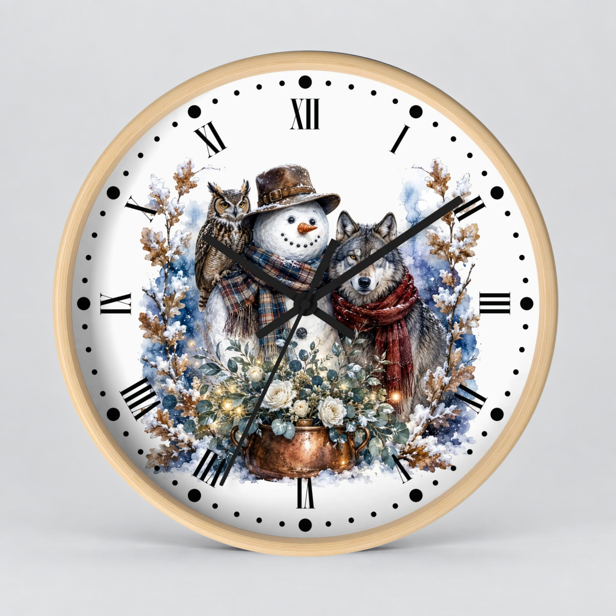 A round wall clock with a light wood frame and a white face, featuring a winter illustration of a snowman, a wolf, an owl, flowers, and a copper pot. The clock has black Roman numerals and black hands and is photographed against a neutral light gray background.
