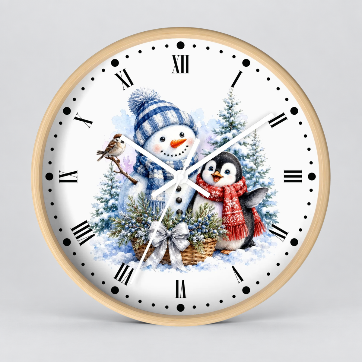 A round wall clock with a light wood frame and a white face featuring a winter holiday illustration of a snowman, a penguin, evergreen trees, and a small bird, with black Roman numerals and black dot hour markers.