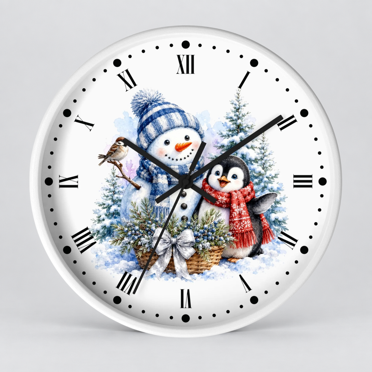 A round white wall clock with black Roman numerals and hands, featuring a festive winter illustration of a snowman in a blue hat and a penguin in a red scarf among snowy trees.