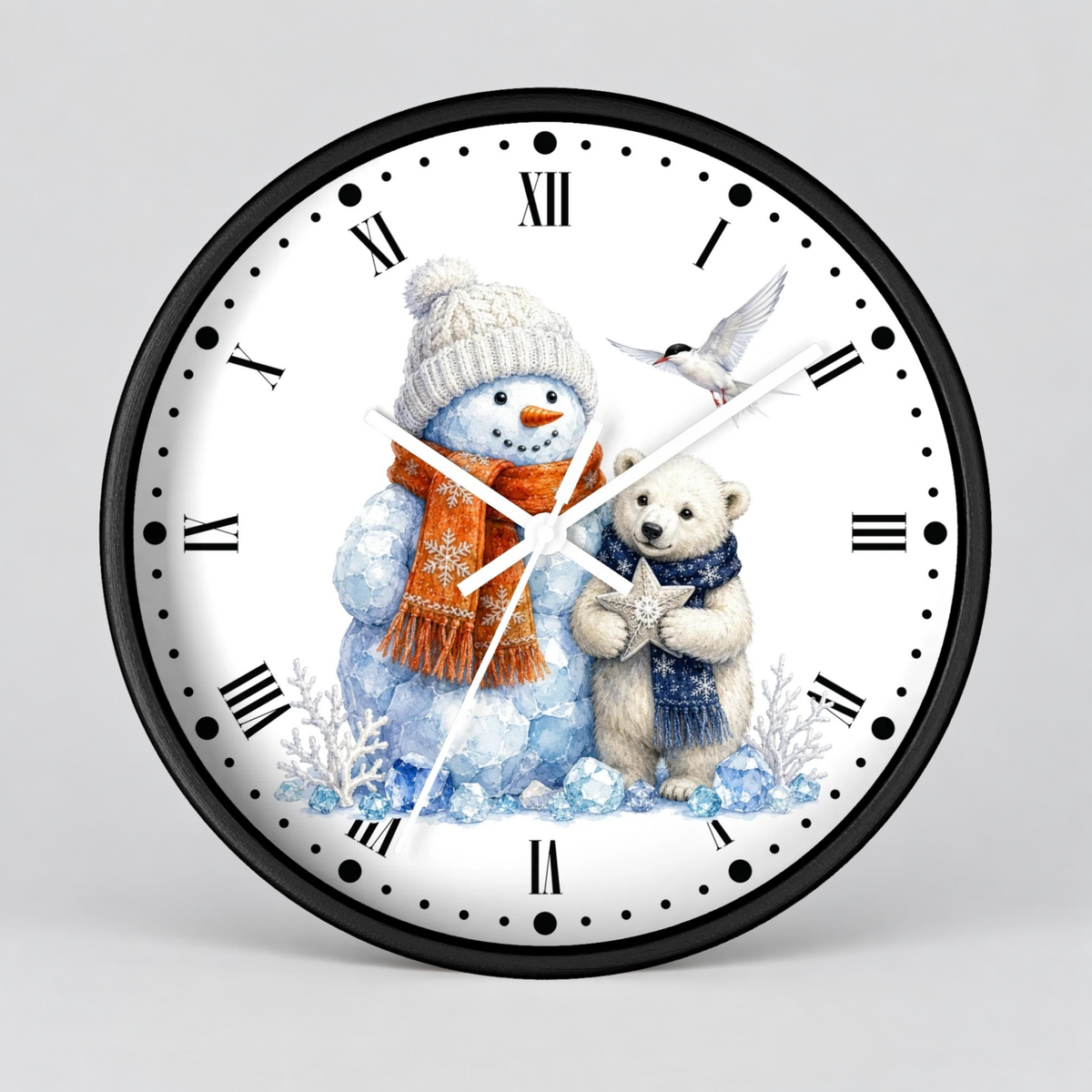 A round wall clock with a black frame and a white face featuring a winter illustration of a snowman in a beige hat and orange scarf next to a polar bear cub holding a star, with black Roman numerals and white hands on a light gray background.