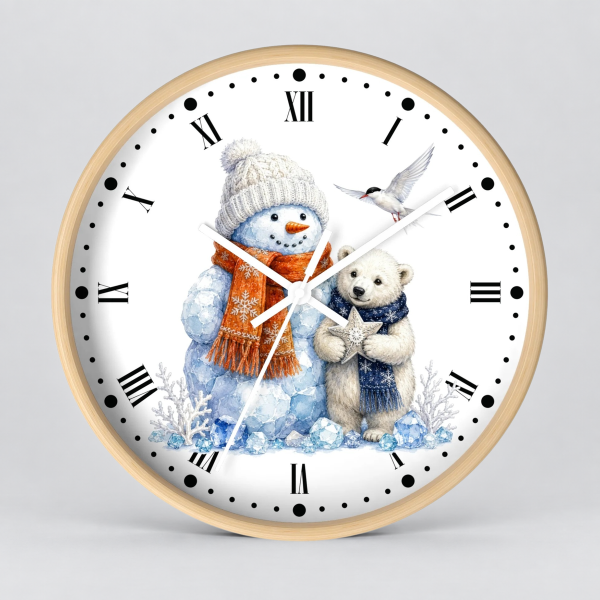 A round wall clock with a light wood frame and a white face, featuring a winter illustration of a snowman in a cream knit hat and orange scarf, a polar bear in a blue scarf holding a star, and a small bird. The clock is centered on a light gray background.