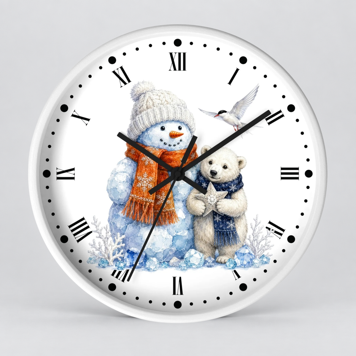 A round white wall clock with black Roman numerals and black hands, featuring a winter illustration of a snowman in a cream knit hat and orange scarf next to a polar bear cub holding a star, with a small bird at the top.