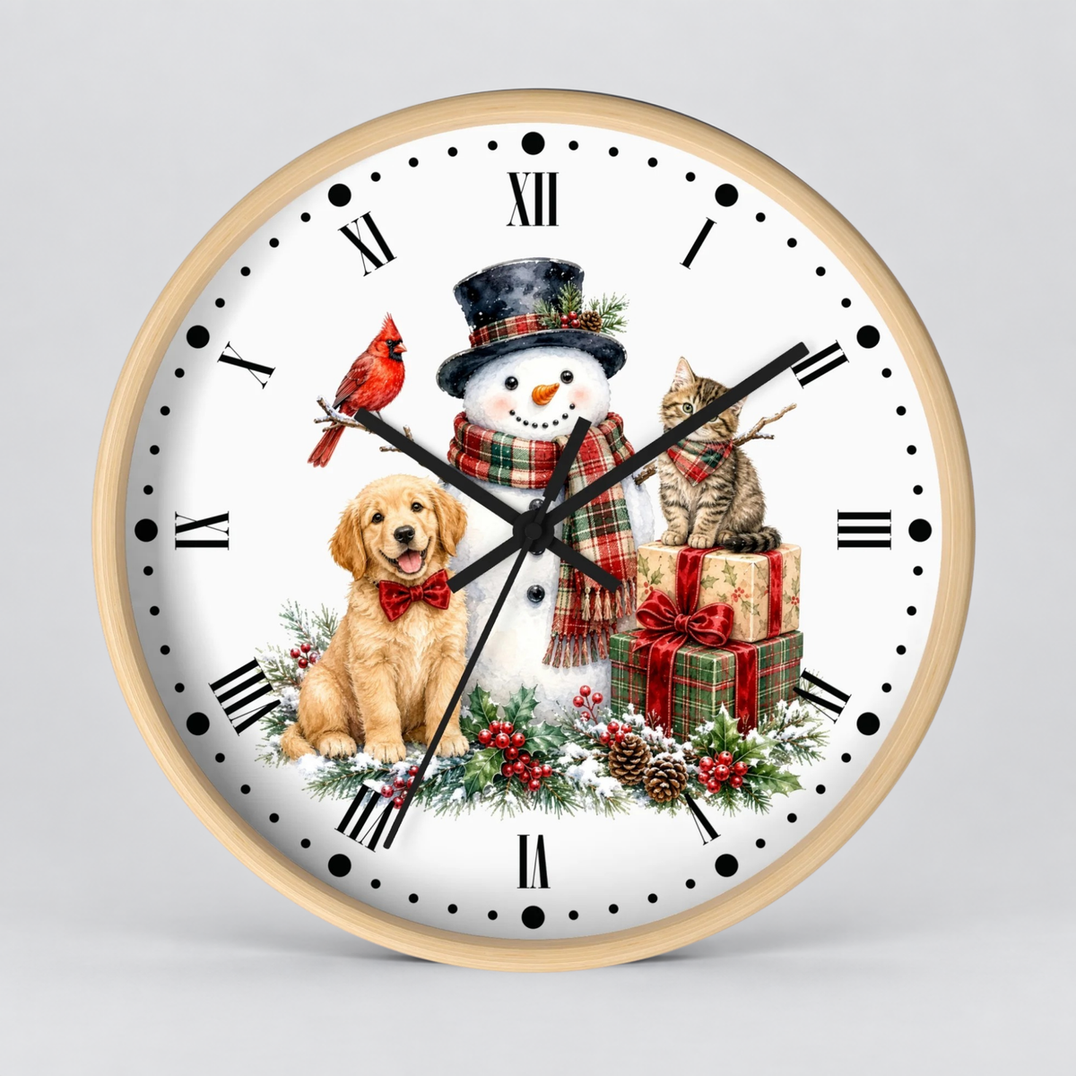 A round wall clock with a light wood frame and a white face featuring a festive holiday illustration of a golden retriever, a snowman, a tabby cat, a red cardinal, wrapped gifts, pinecones, and greenery. The clock is shown against a neutral light gray background.