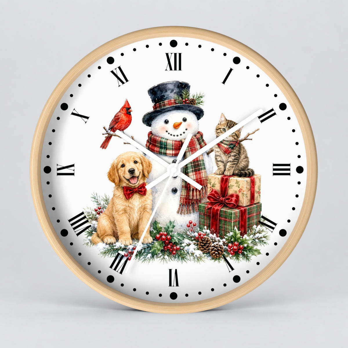 A round wall clock with a light wood frame and a white face featuring a festive Christmas scene with a snowman, golden retriever dog, red bird, tabby cat, red gift boxes, pinecones, and green holly. The clock is shown against a neutral light gray background.