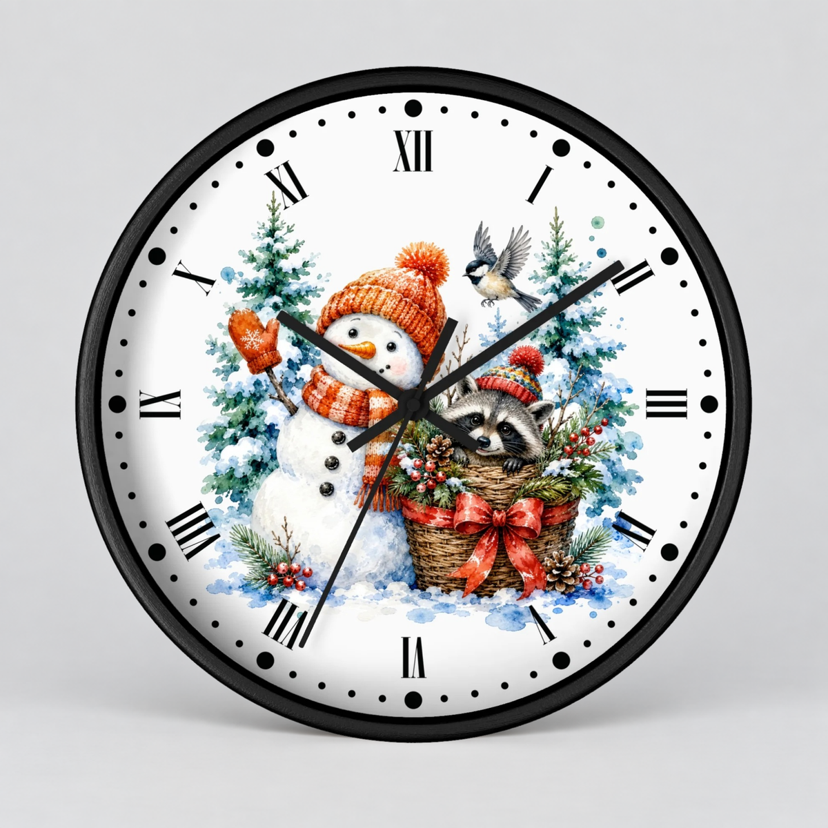 A round black-framed wall clock with a white face featuring a festive winter illustration of a snowman in an orange hat and scarf, a raccoon in a basket, evergreen trees, and a bird, with black Roman numerals and hands on a light gray background.