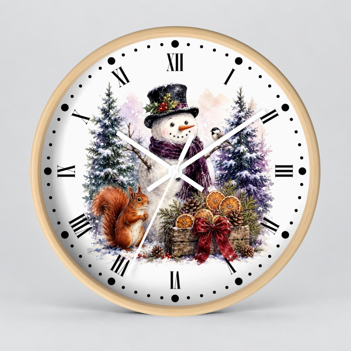 A round wall clock with a light wood frame and a white face featuring a winter holiday illustration of a snowman, a squirrel, evergreen trees, and orange lanterns, set against a neutral gray background.