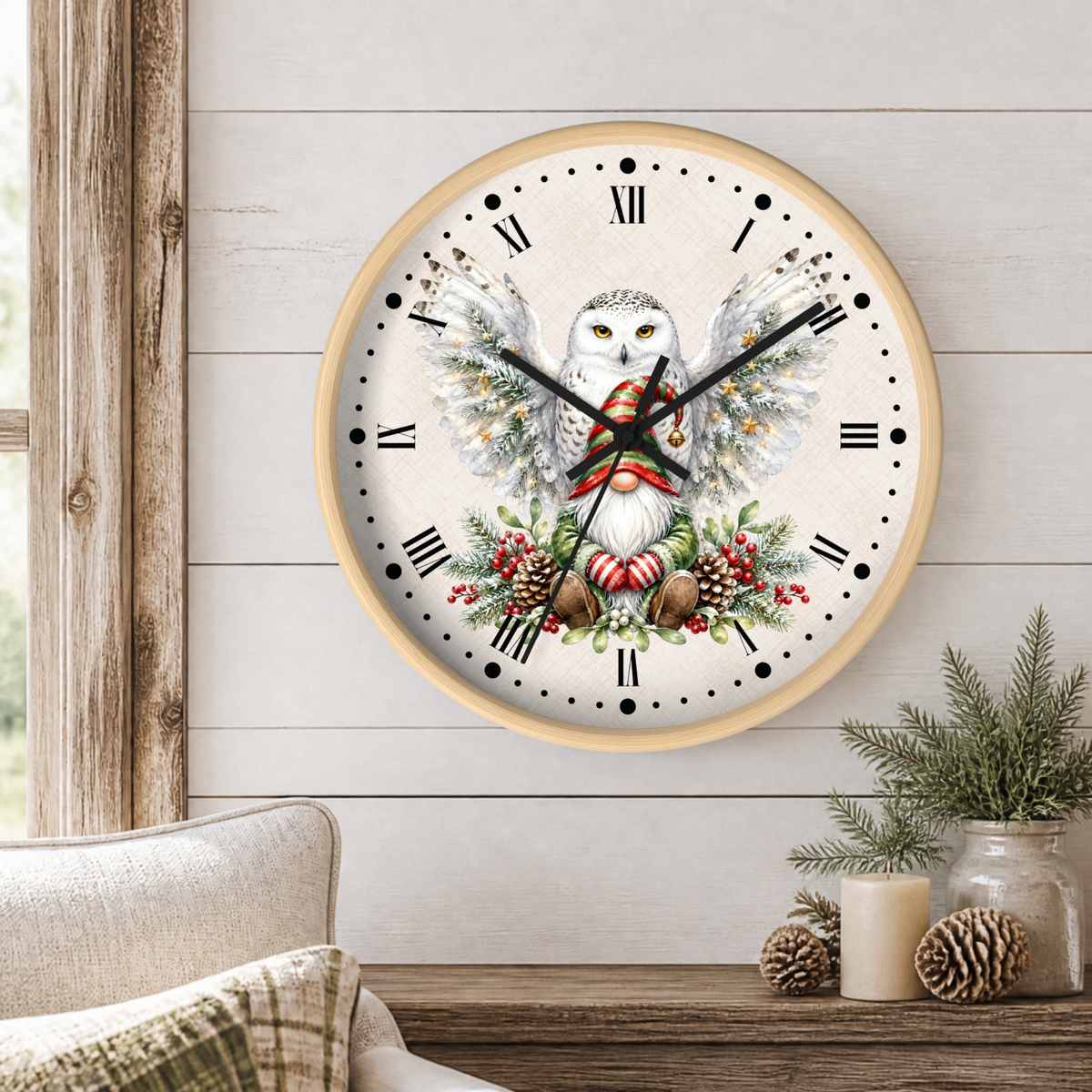 A round wall clock with a light wood frame hangs on a white shiplap wall above a rustic table. The clock face features a detailed illustration of a white owl with large wings, holding a red-and-white striped candy cane, surrounded by evergreen branches, red berries, and pinecones.