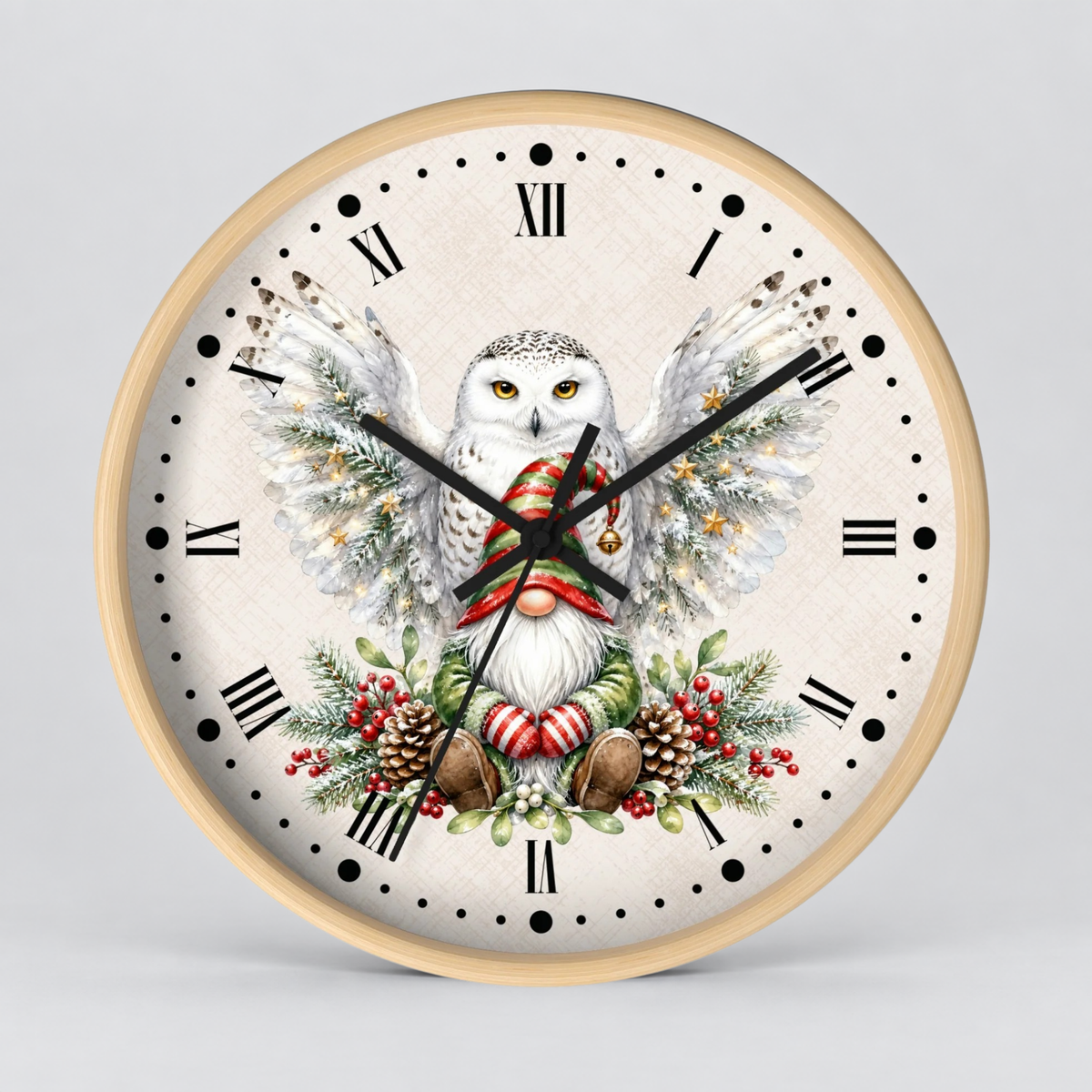 A round wall clock with a light wood frame and a cream-colored face, featuring a detailed illustration of a snowy owl with outstretched wings, a red and white striped scarf, and festive greenery and pinecones.