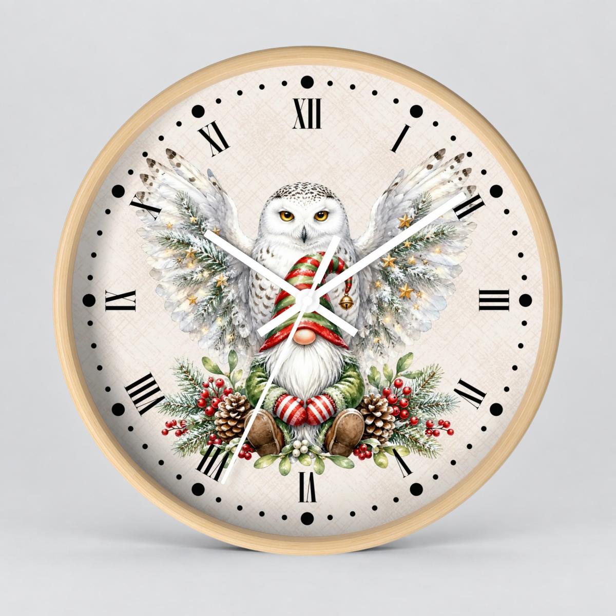 A round wall clock with a light wood frame and a festive printed dial featuring a snowy owl with outstretched wings, red holiday accents, pinecones, and evergreen branches on a light beige background.