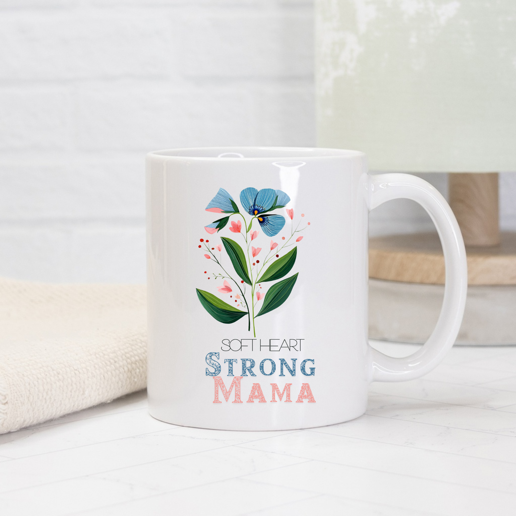 11oz white ceramic mug with floral design and 'Soft Heart Strong Mama' text on a light background