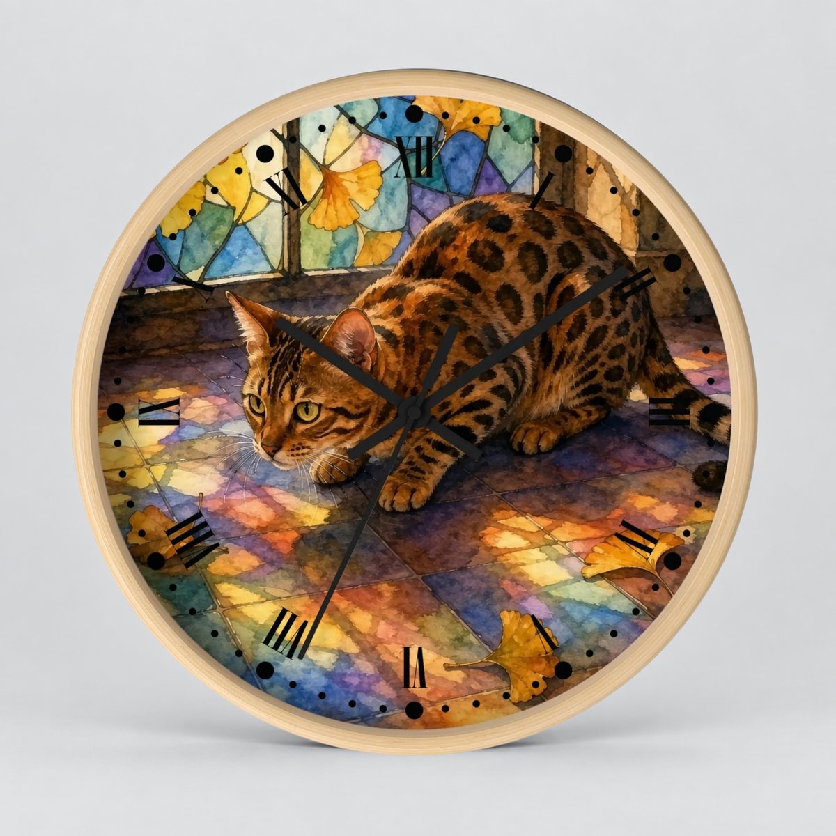 A round wall clock with a light natural wood frame, featuring a colorful printed face of a spotted cat in a stained-glass style scene with Roman numerals and black clock hands.