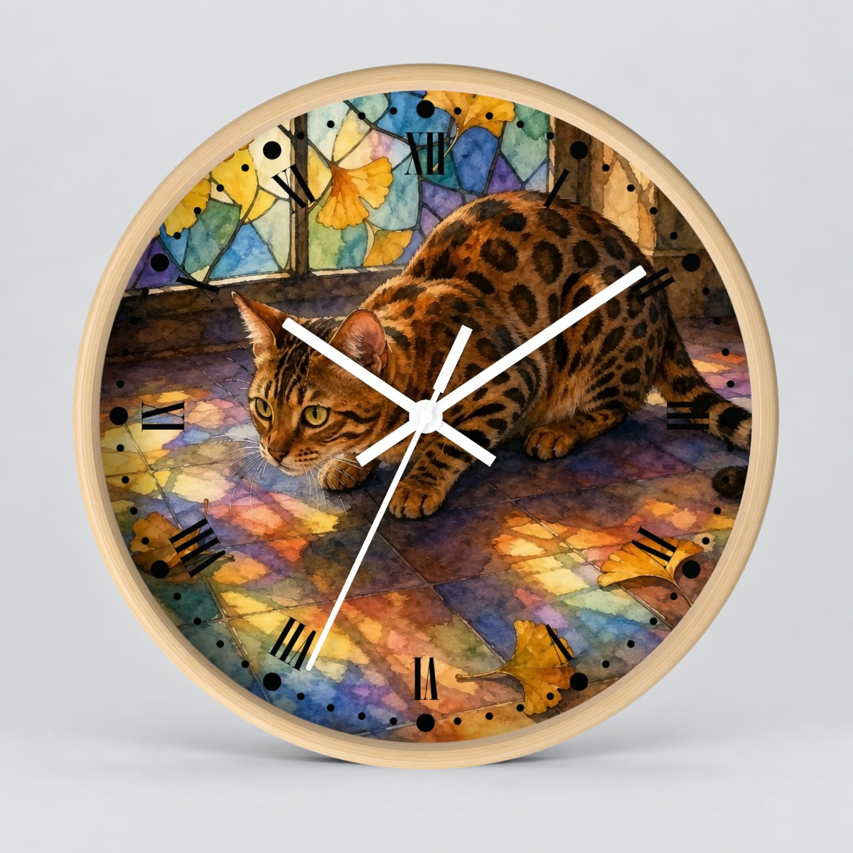 A round wall clock with a light wood frame and white hands, featuring a colorful watercolor-style illustration of a spotted cat on the clock face against a light gray studio background.