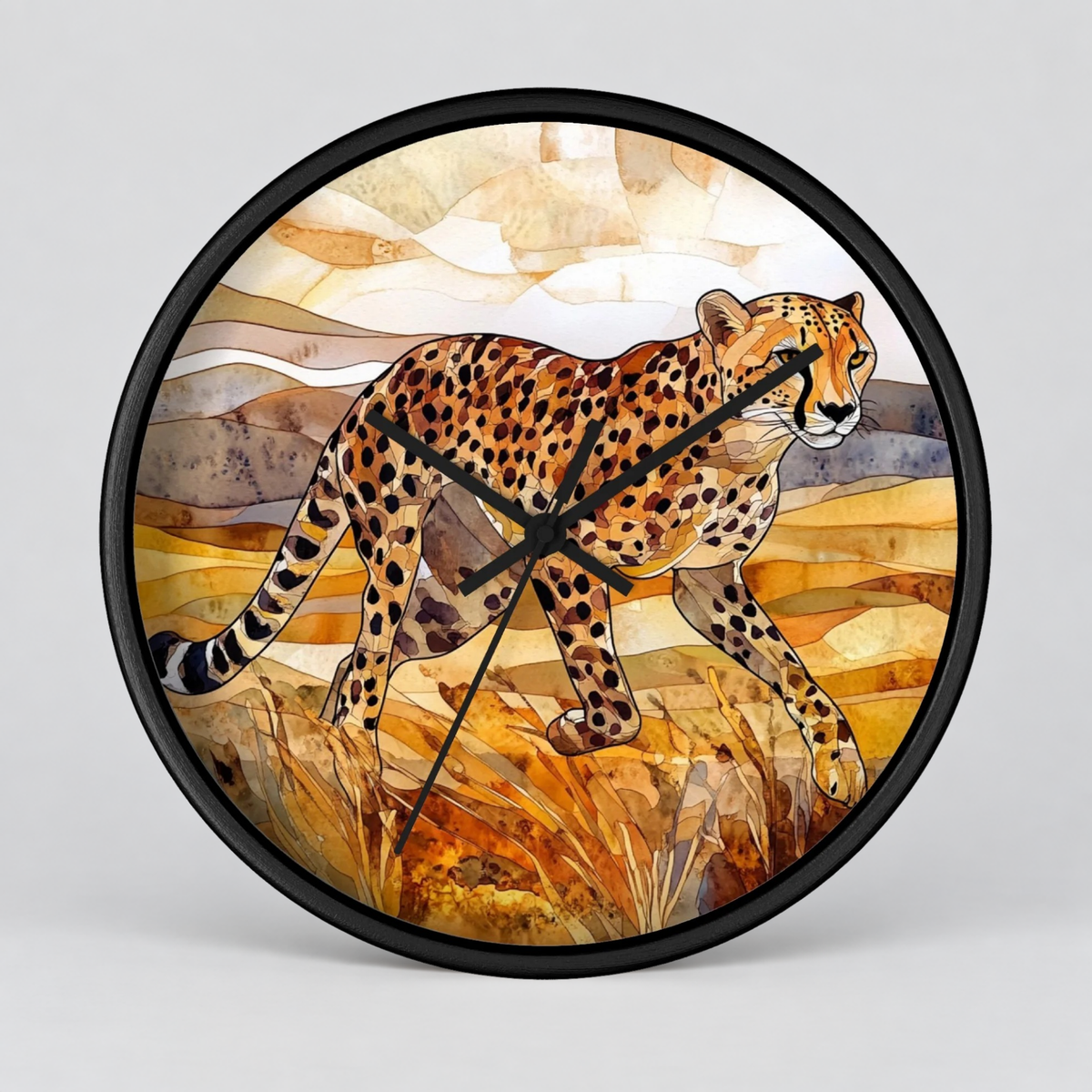 Round wall clock with a black frame and black hands, featuring a watercolor-style illustration of a cheetah walking through golden grass against warm beige and brown landscape shapes.