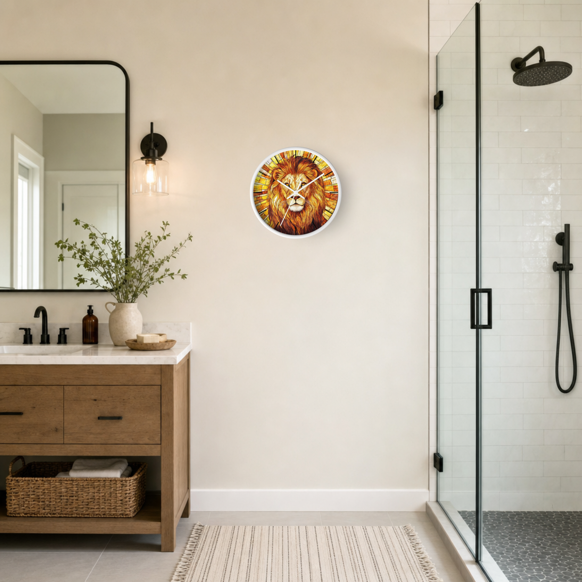 A round wall clock featuring a detailed lion face illustration, mounted on a beige wall in a modern bathroom setting with a wooden vanity, mirror, and glass shower door.