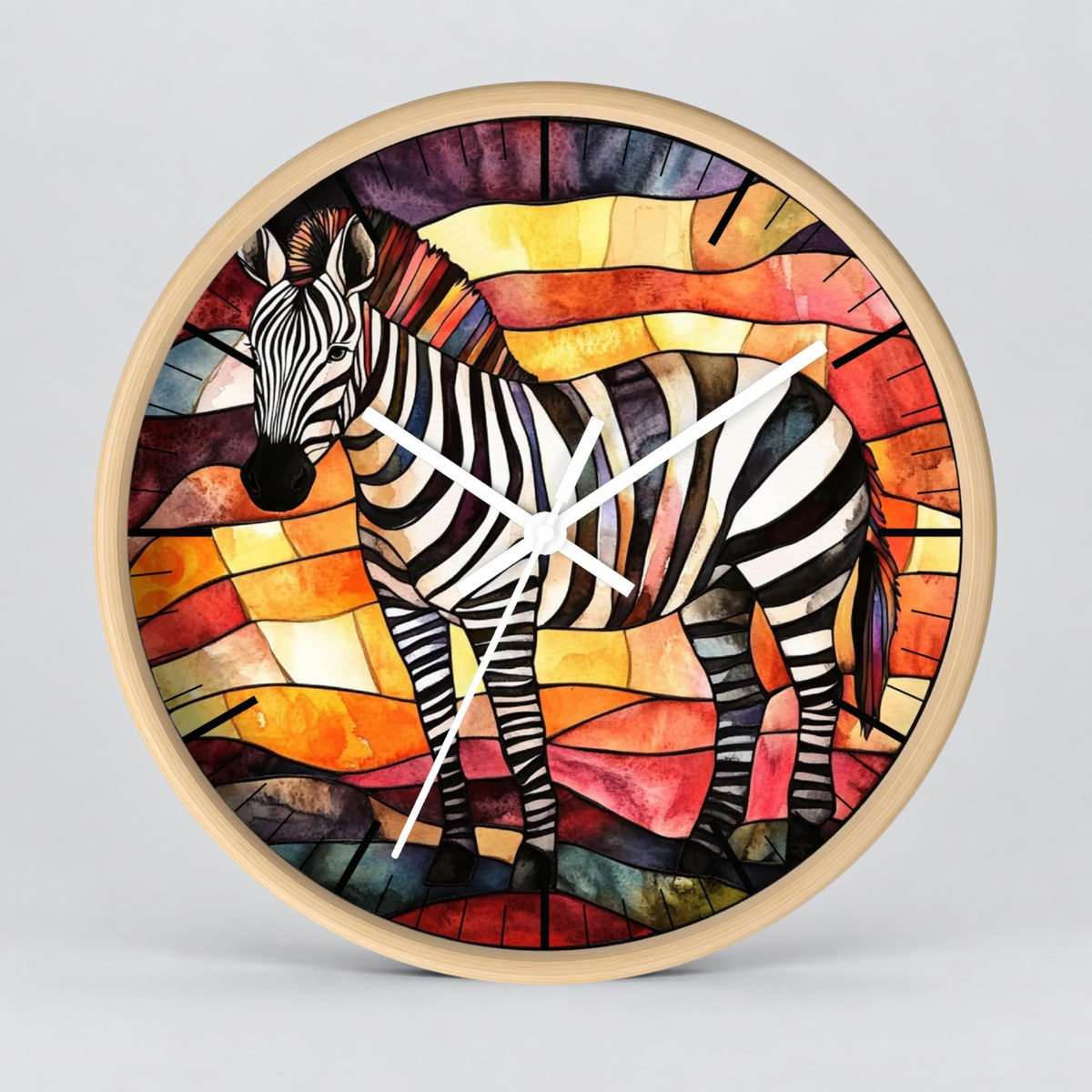 A round wall clock with a light natural wood frame, featuring a colorful stained-glass style illustration of a zebra on the face. The clock hands are white, and the background is a clean, neutral gray studio backdrop.
