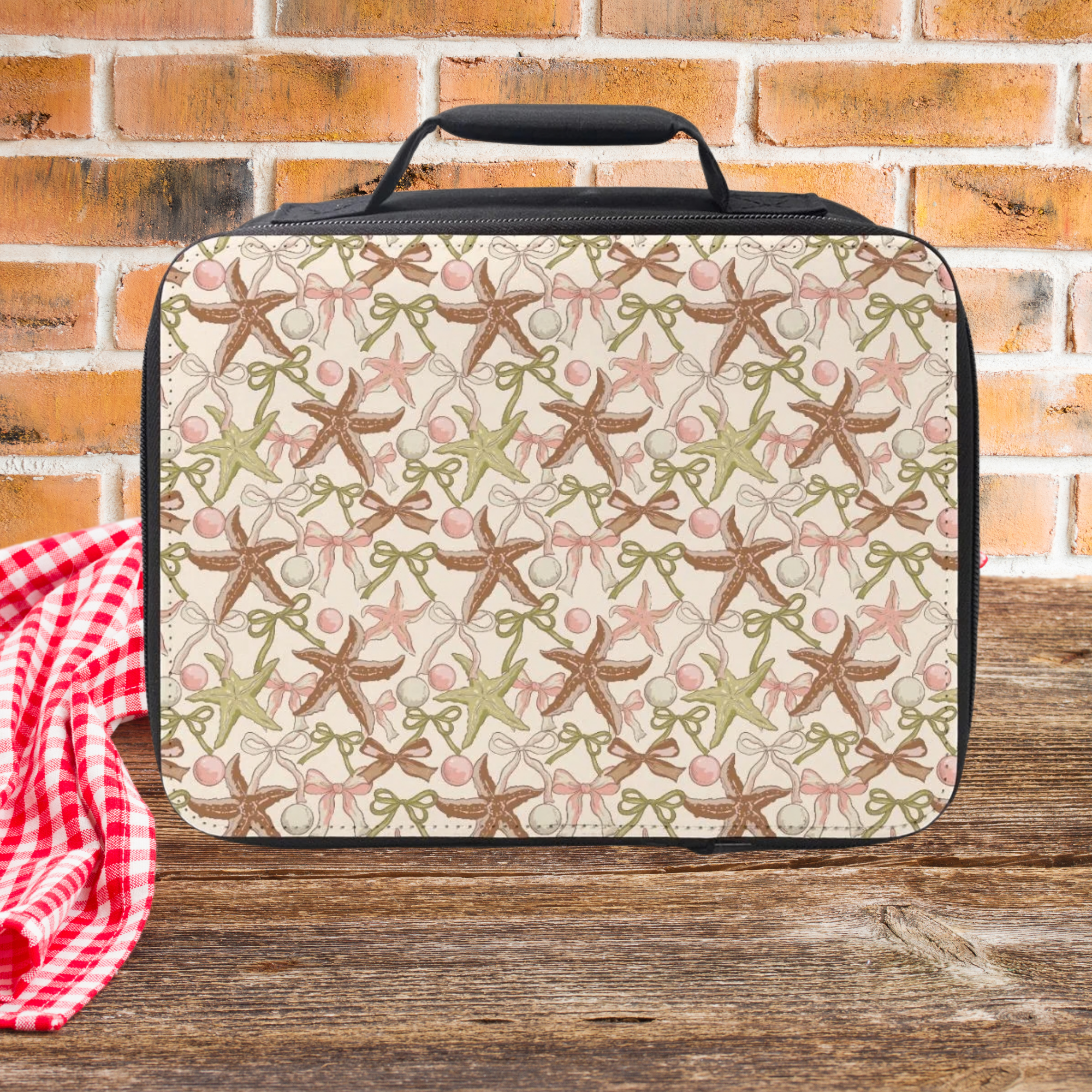 Lunch bag with starfish pattern on a wooden surface and brick wall background