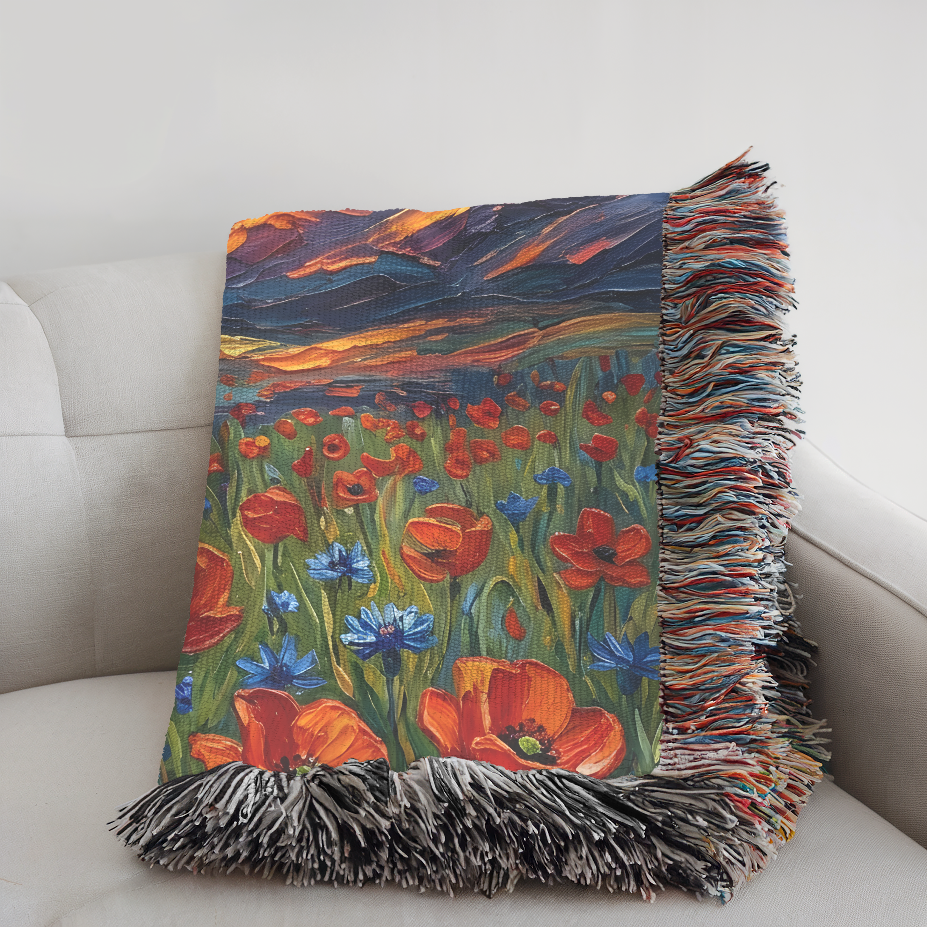 Folded colorful floral woven blanket with fringe on a white couch