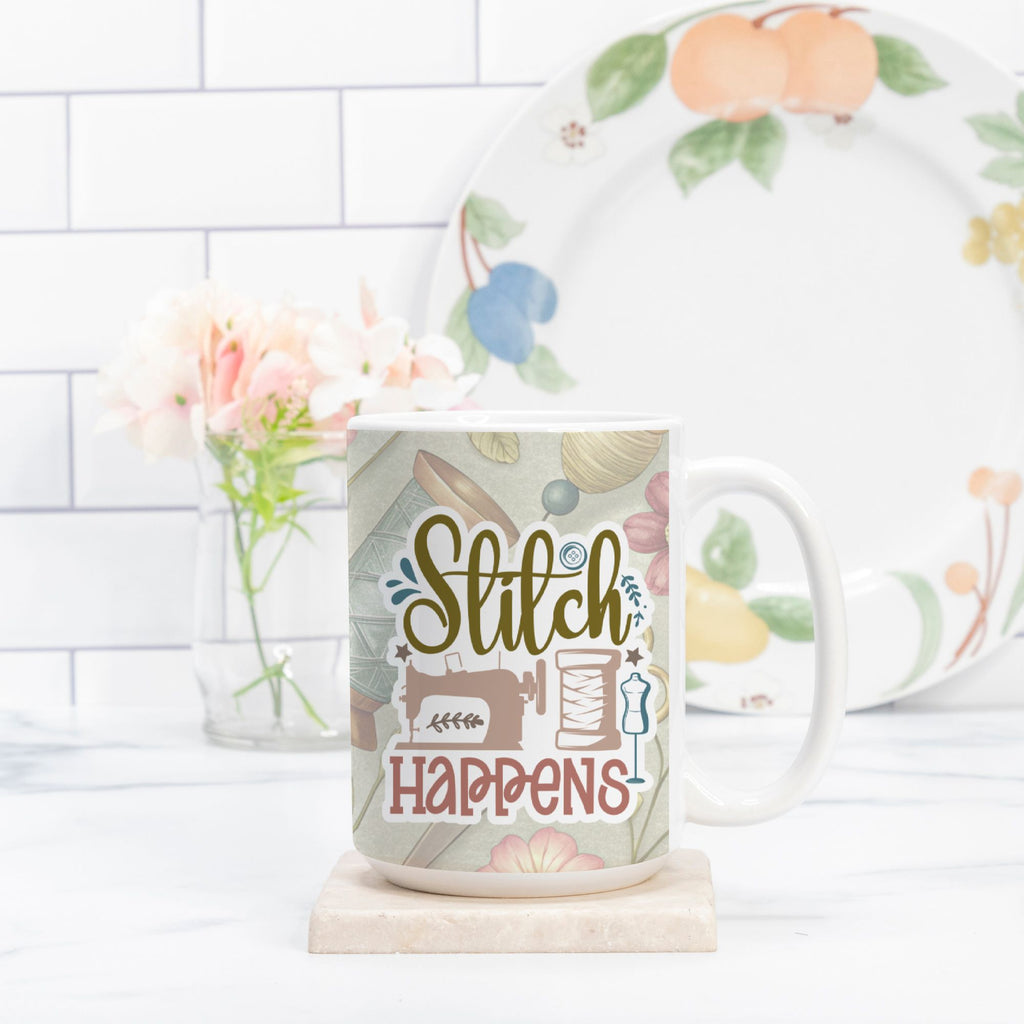 Mug with 'Stitch Happens' design on a marble surface with a floral plate in the background.