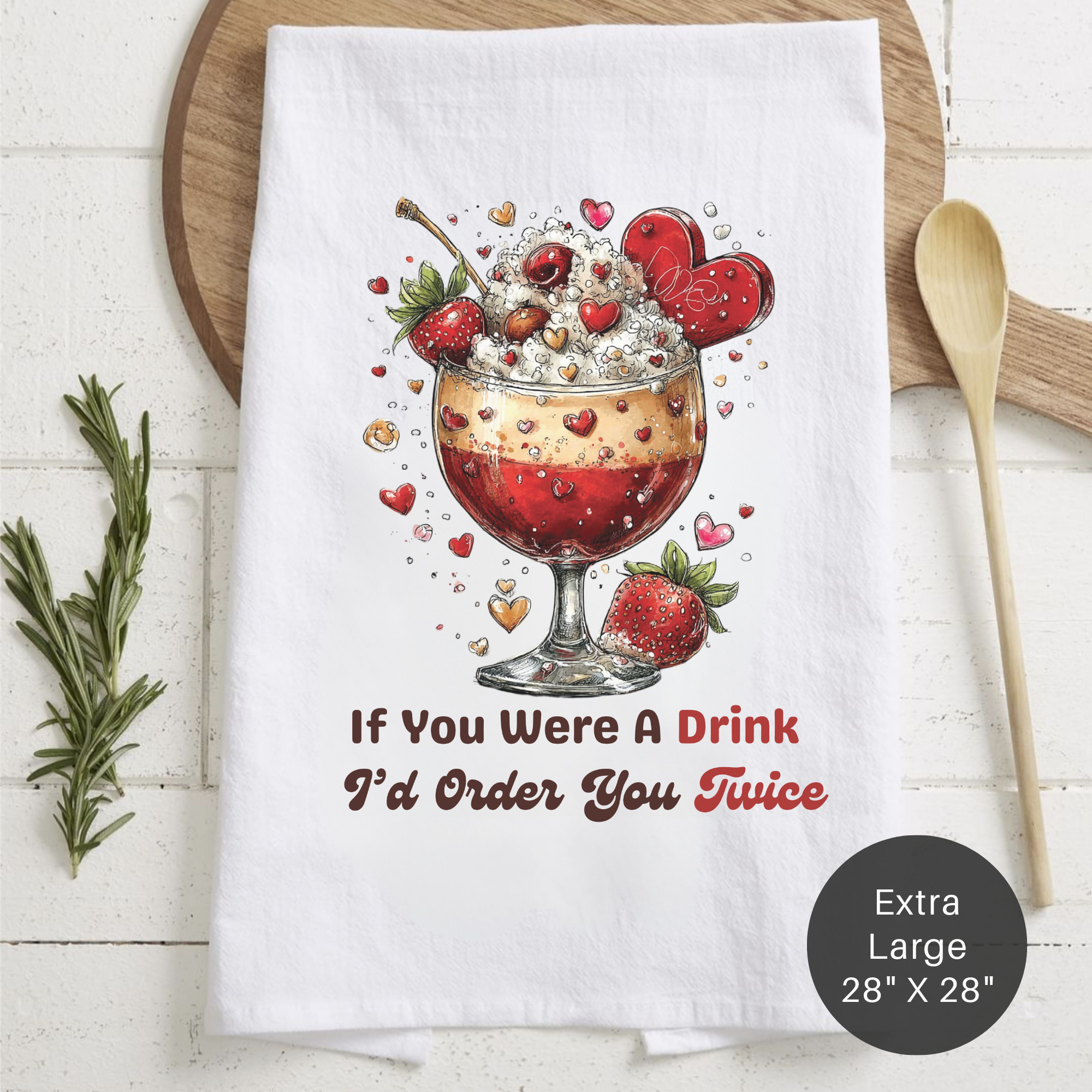 Tea towel with a drink illustration and text ' If You Were A Drink I'd Order You Twice' on a wooden board.