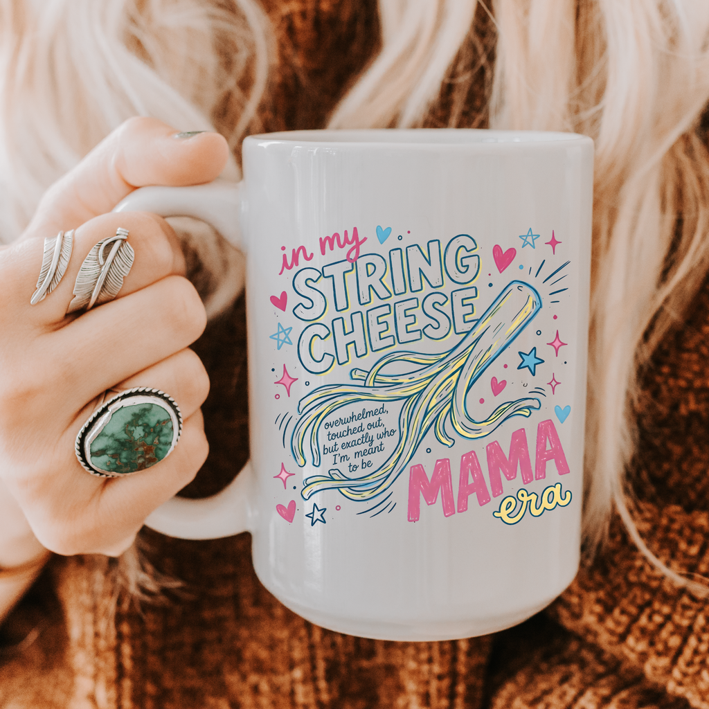 Person holding a mug with 'in my string cheese mama era' design.