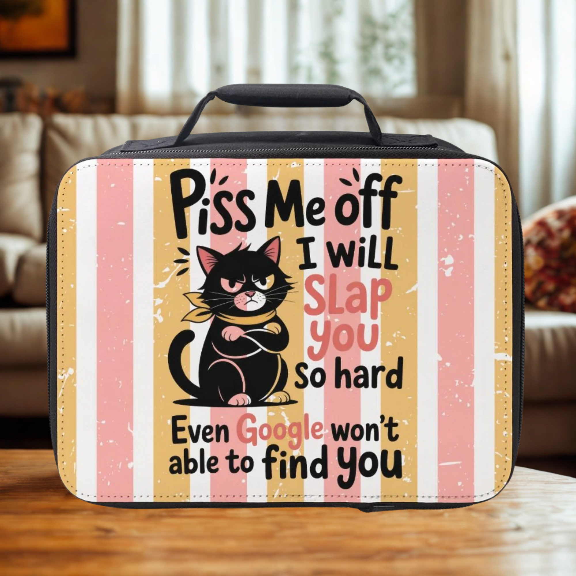 Lunch bag with a black cat graphic and humorous text on a striped background sitting on a wooden living room table.