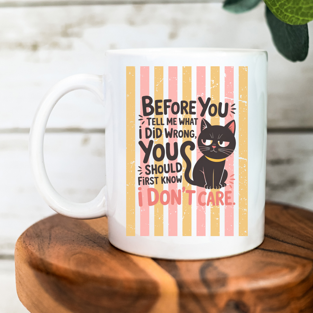 White 15oz mug with a black cat illustration and humorous text on a wooden surface.