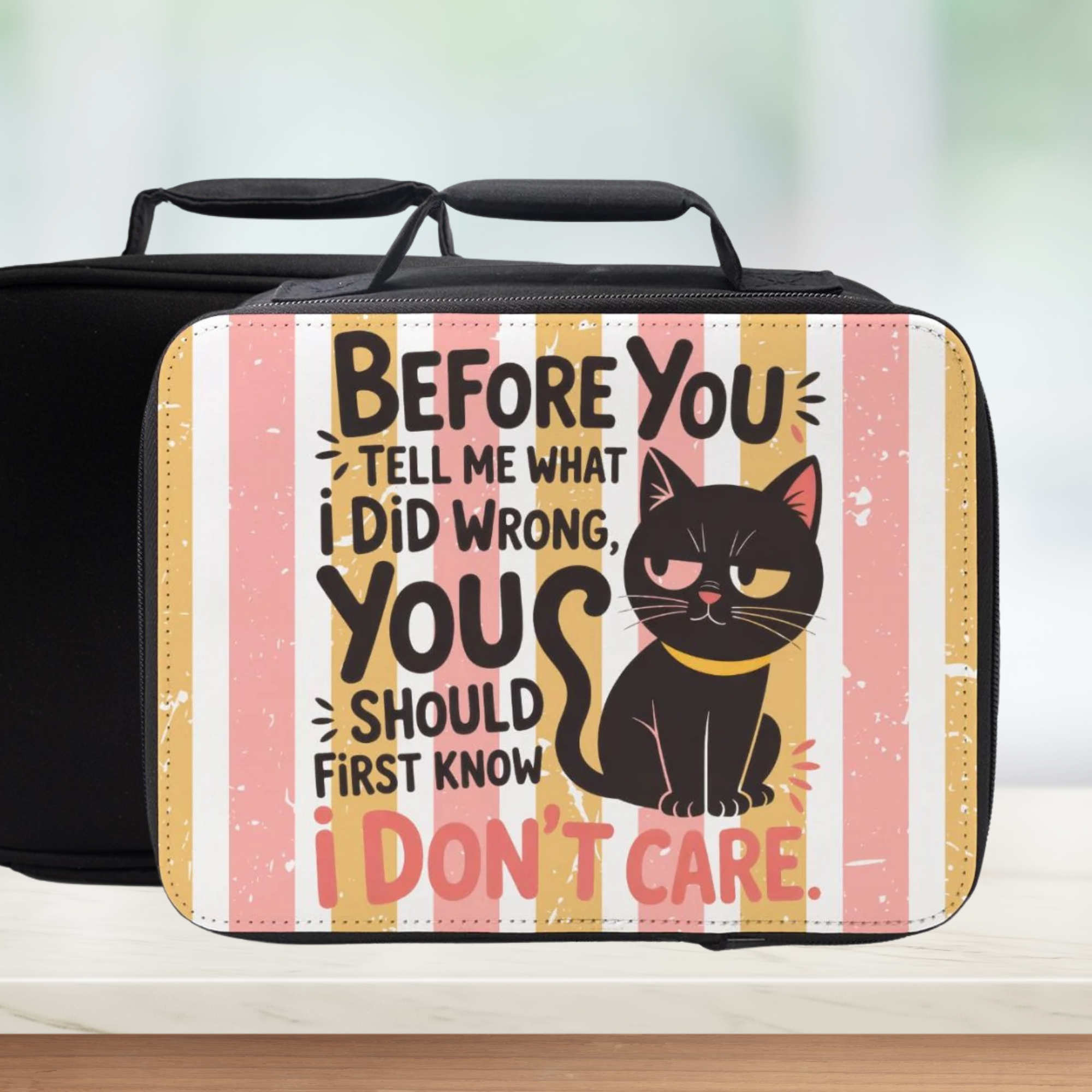 Black cat illustration on a lunch box with text against a striped background