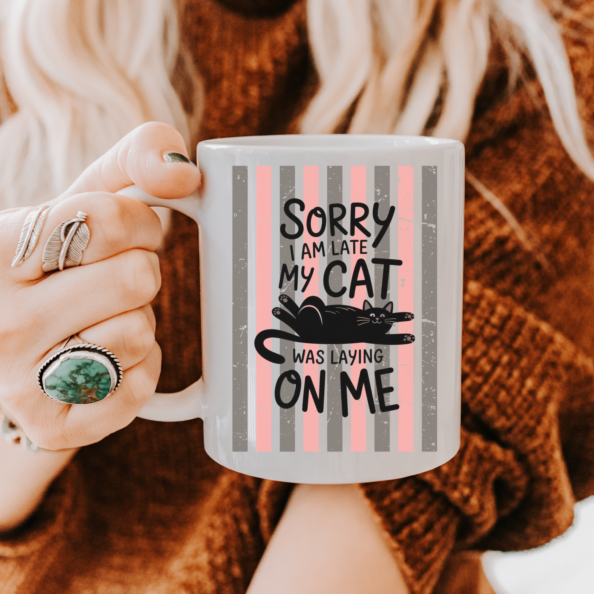 Person holding a 11oz mug with a humorous cat-themed design and text.