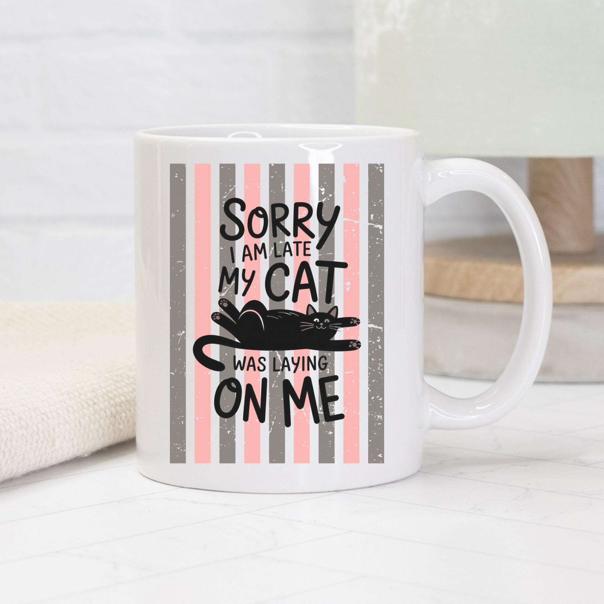 White 11oz mug with a black cat graphic and text on a striped background