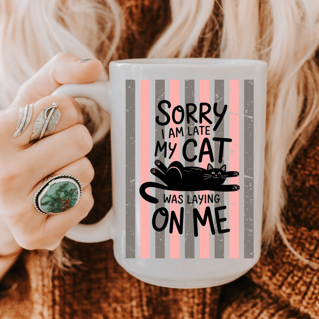 Person holding a 15oz mug with a cat-themed design and text.