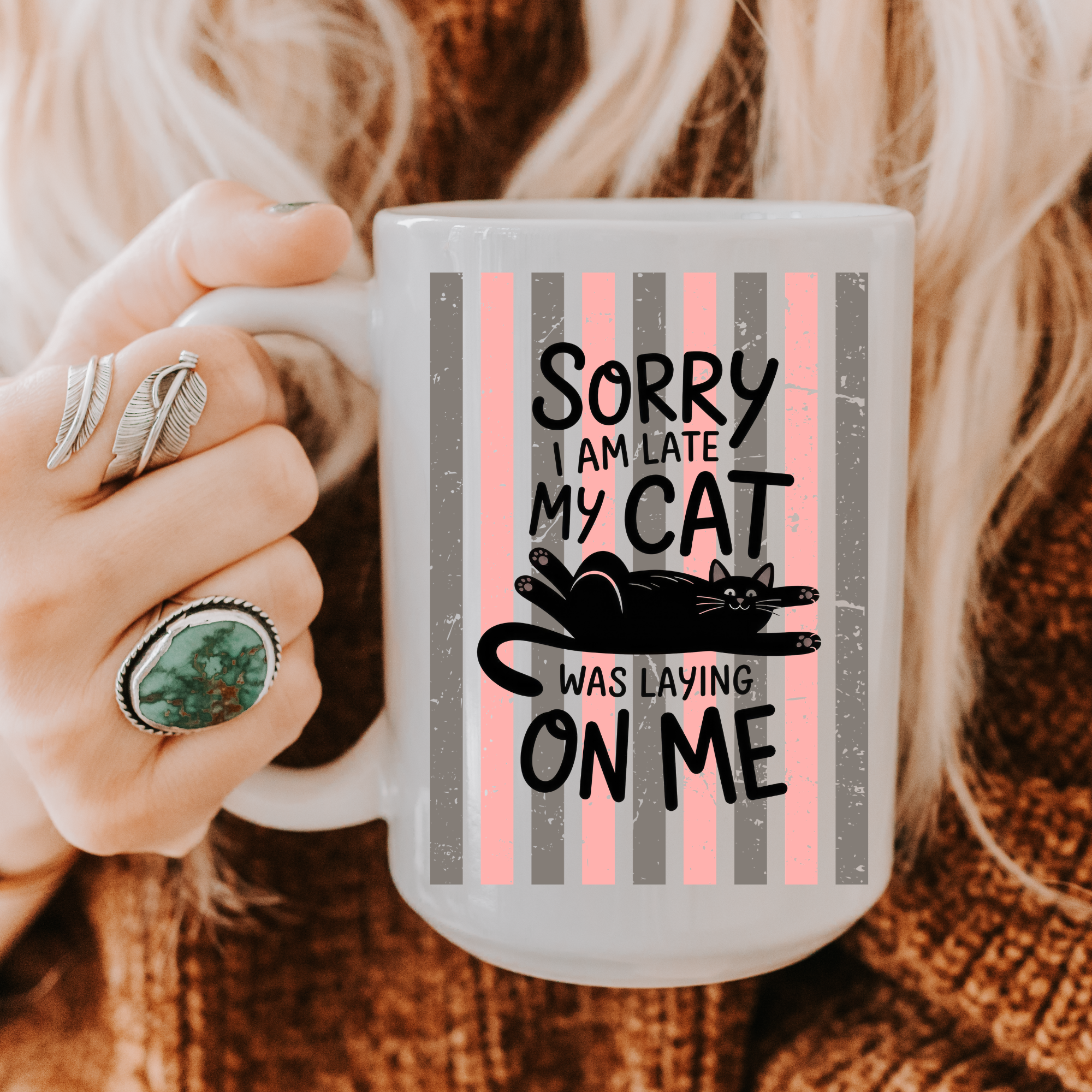Person holding a 15oz mug with a cat-themed design and text.