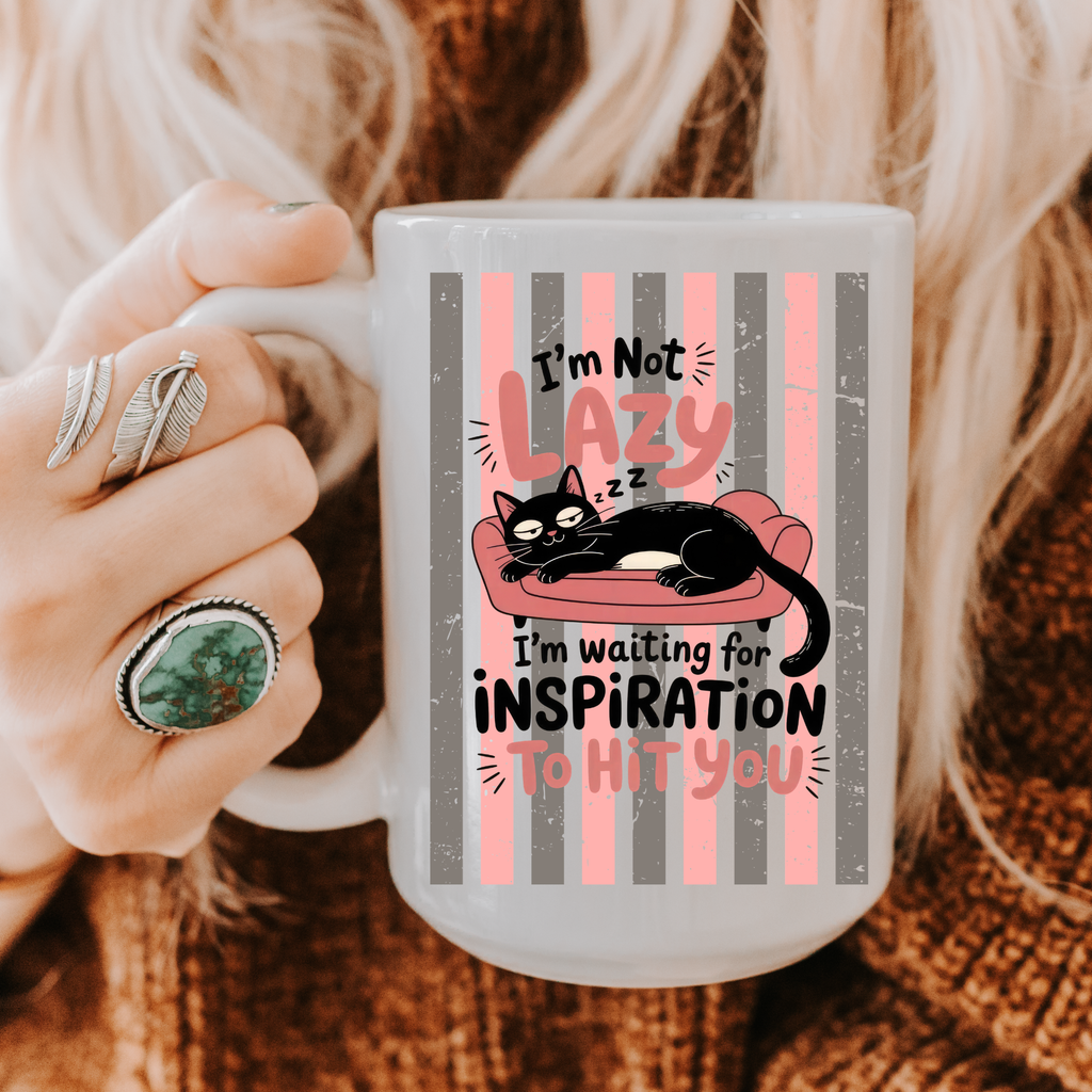 Person holding a 15oz mug with a cat design and text, wearing rings.