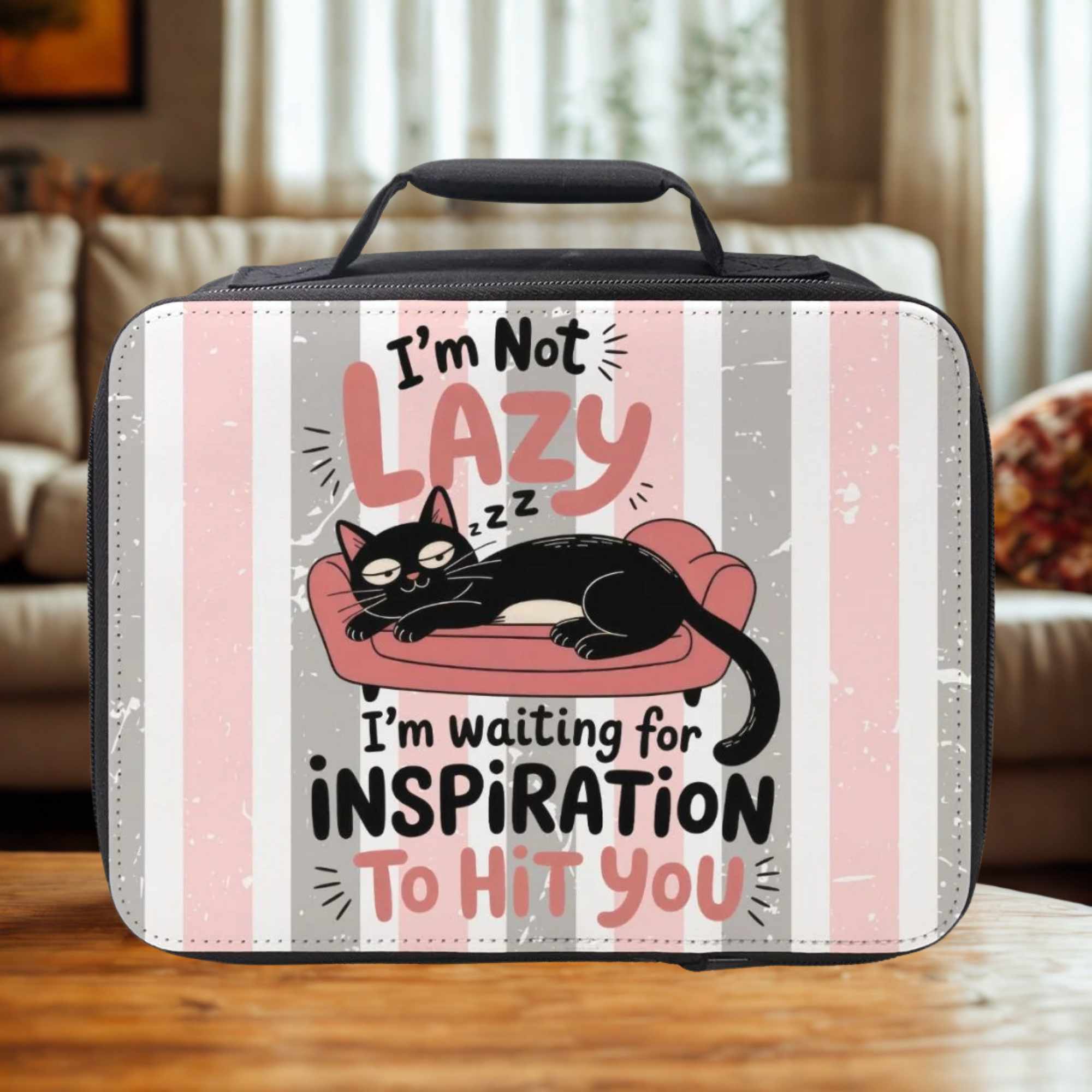 Lunch bag with a cat illustration and text on a wooden living room table.