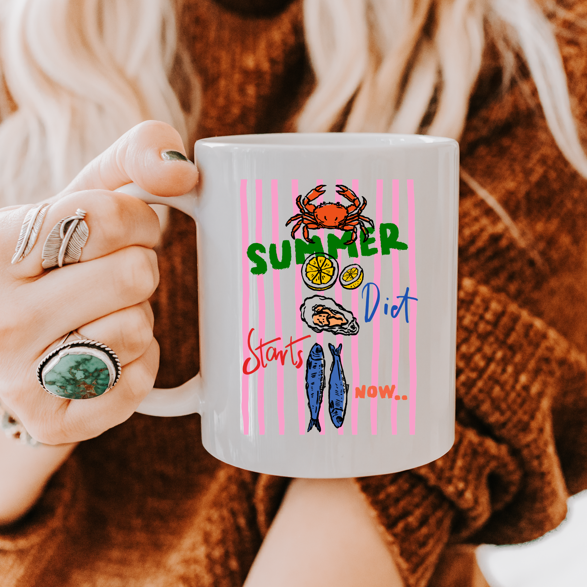 Person holding a 15oz.  mug with a summer-themed design featuring seafood illustrations and text.
