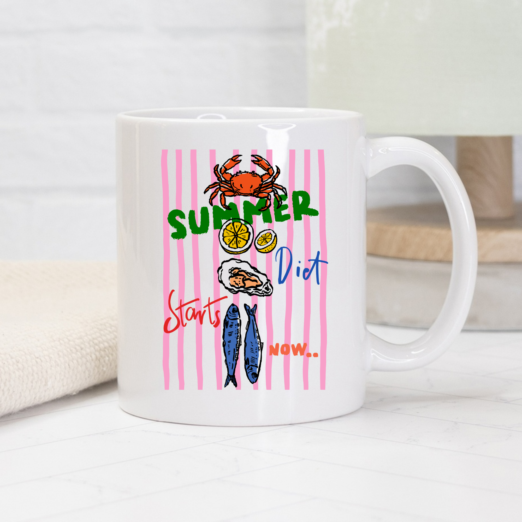 White 11oz, mug with summer-themed design featuring a crab, lemon, fish, and text on a white background. 