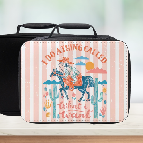 Black lunch bag with a colorful striped design featuring a frog on a horse and cacti.