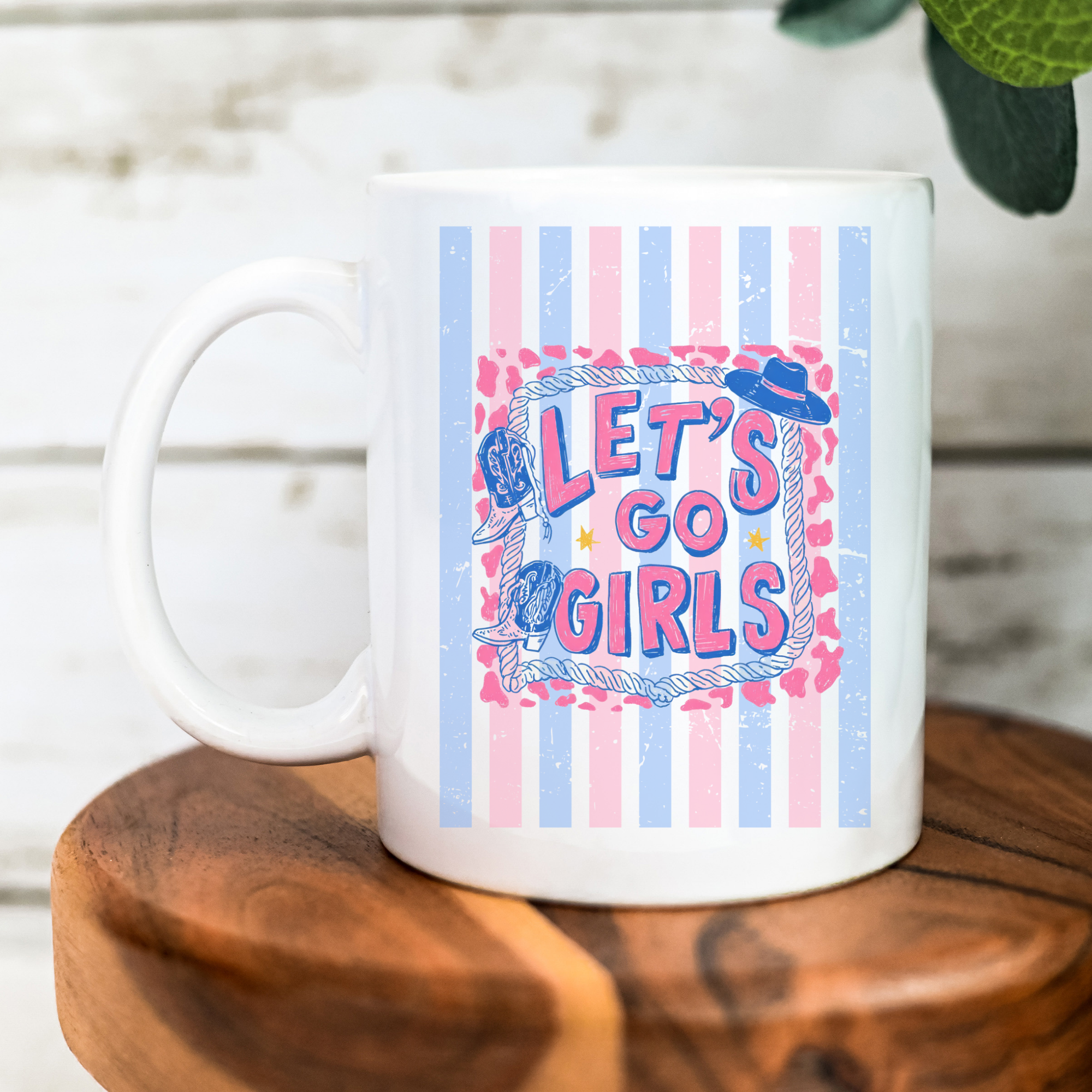 White 11oz. mug with striped 'Let's Go Girls' design on a wooden surface