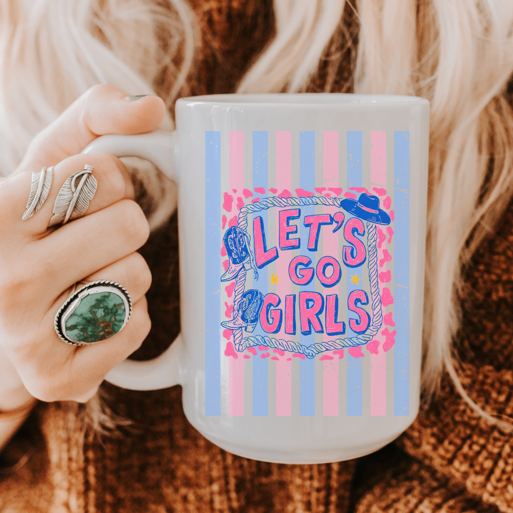 Person holding a 15oz. mug with trendy  'Let's Go Girls' design and striped pattern.