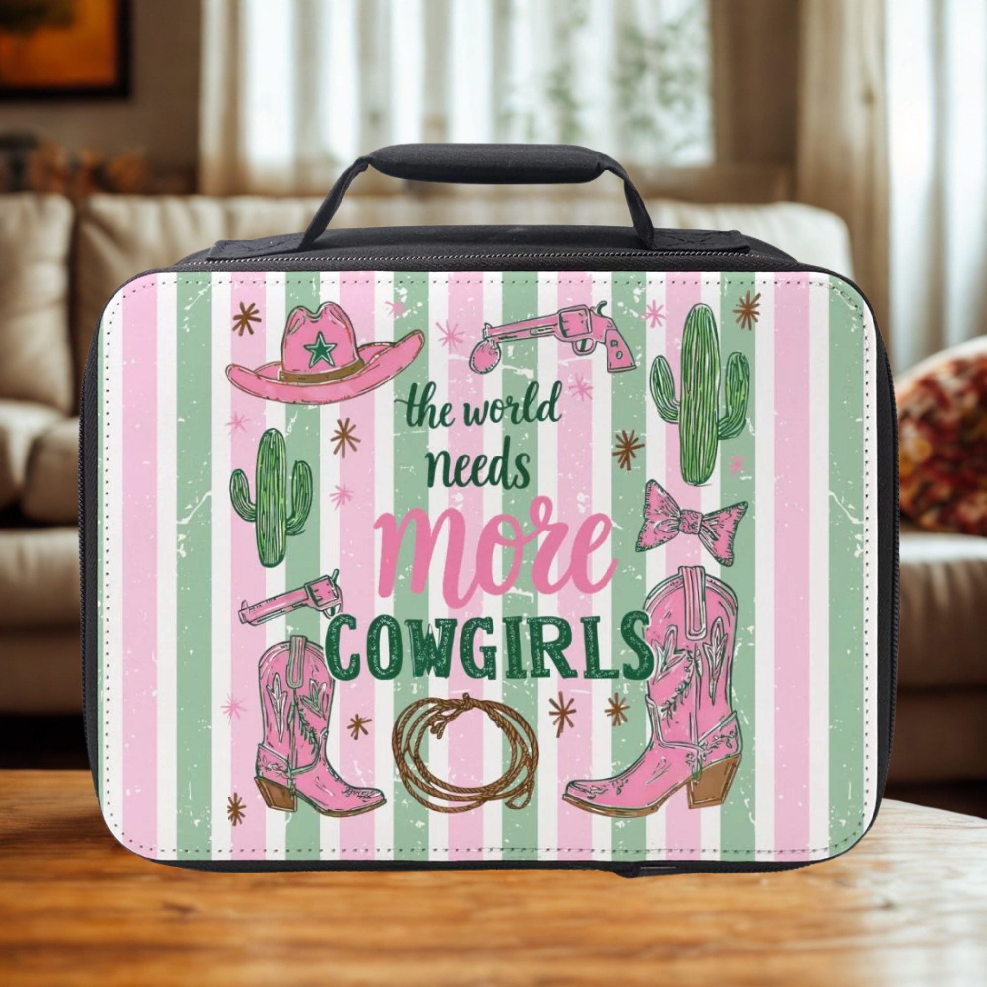  insulated lunch bag with cowgirl design and text 'the world needs more cowgirls' on a striped background