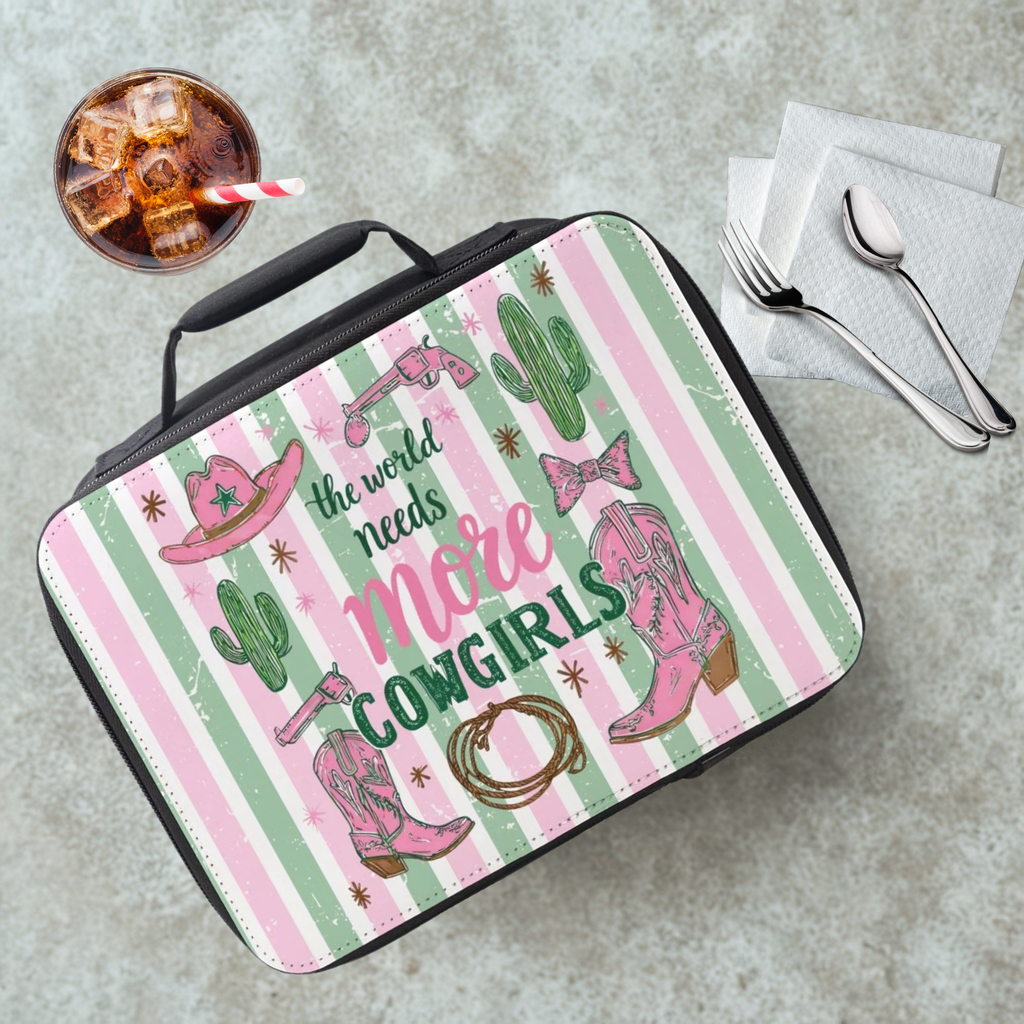 Lunch bag with striped cowgirl design and text on a cafeteria table with a drink and utensils.