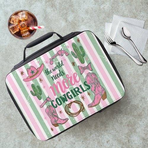 Lunch bag with striped cowgirl design and text on a cafeteria table with a drink and utensils.