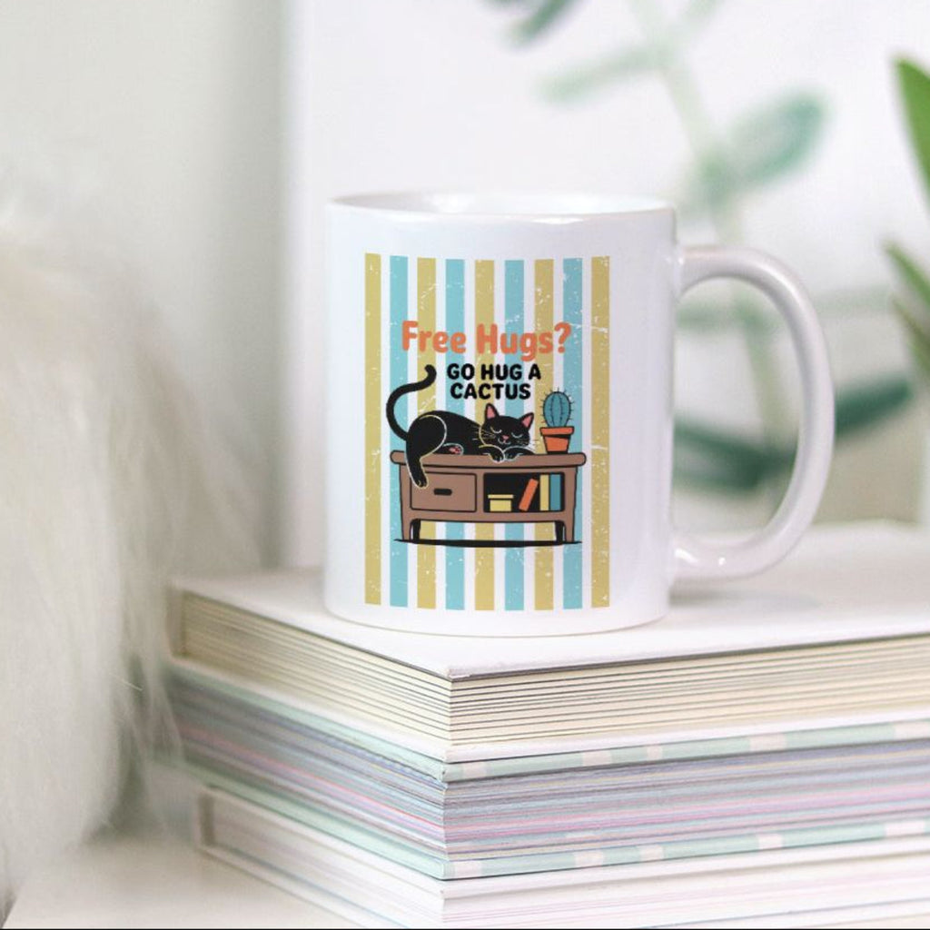 11oz Mug with a cat and cactus design on a stack of books with a plant in the background